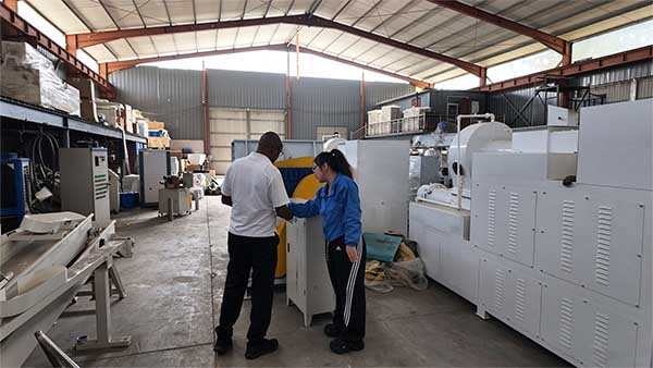 Customer visiting factory to check soap production line machines for soap manufacturing business