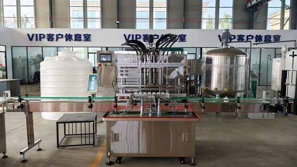 8-head automatic liquid filling machine displayed in factory showroom, paired with mixing tank for liquid soap and shampoo production