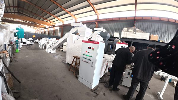 Technicians test automatic toilet soap and laundry soap making machine inside Bright Machinery factory workshop