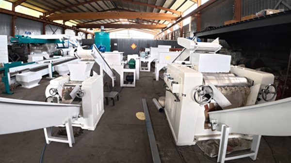 Complete soap making machine line including mixer, triple roll mill, plodder and cutter inside workshop